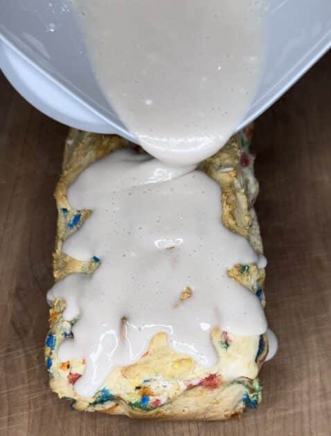 Pouring icing on ice cream bread
